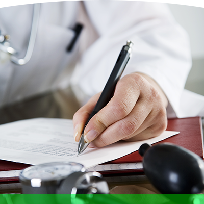 Doctor writing on piece of paper