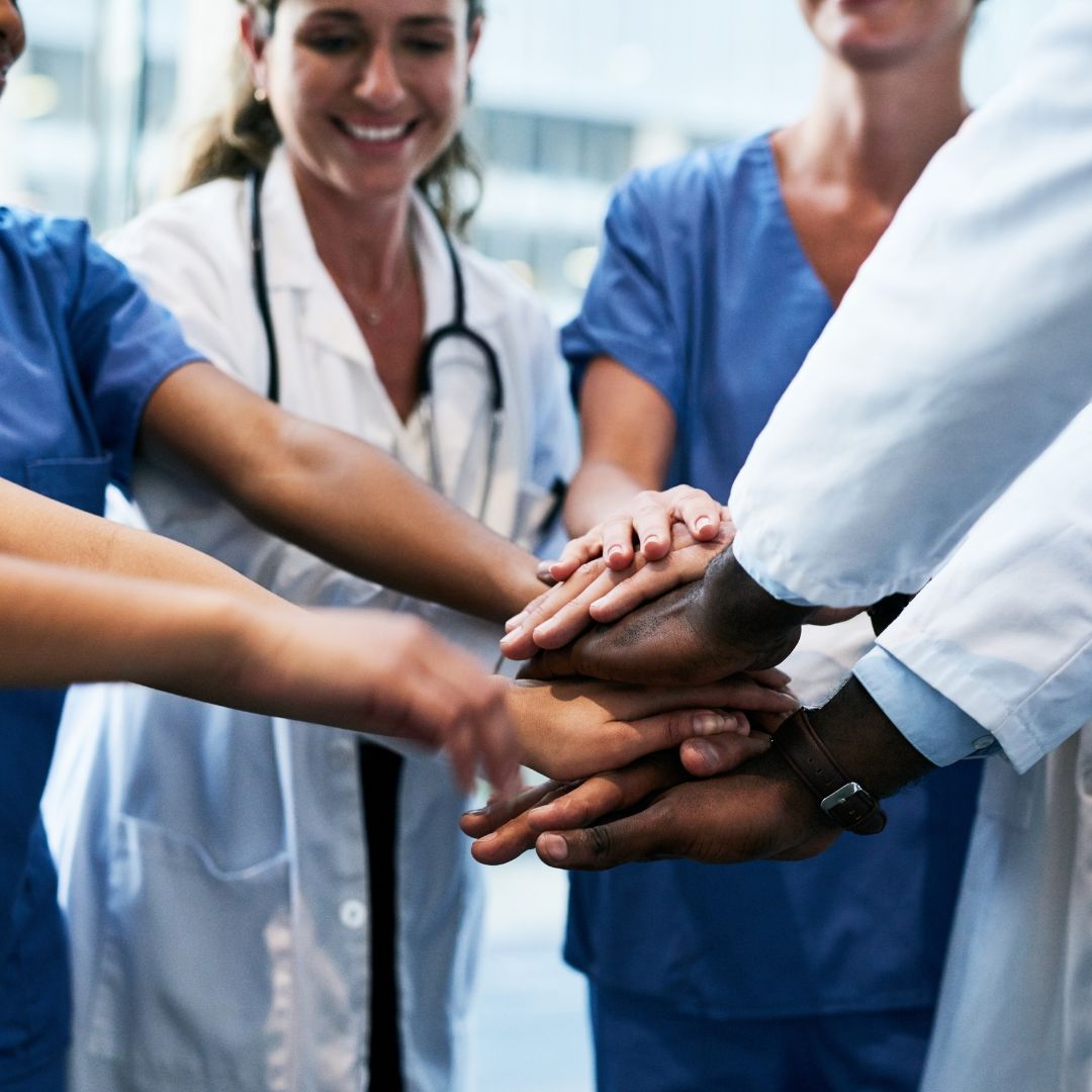 healthcare staff putting hands together