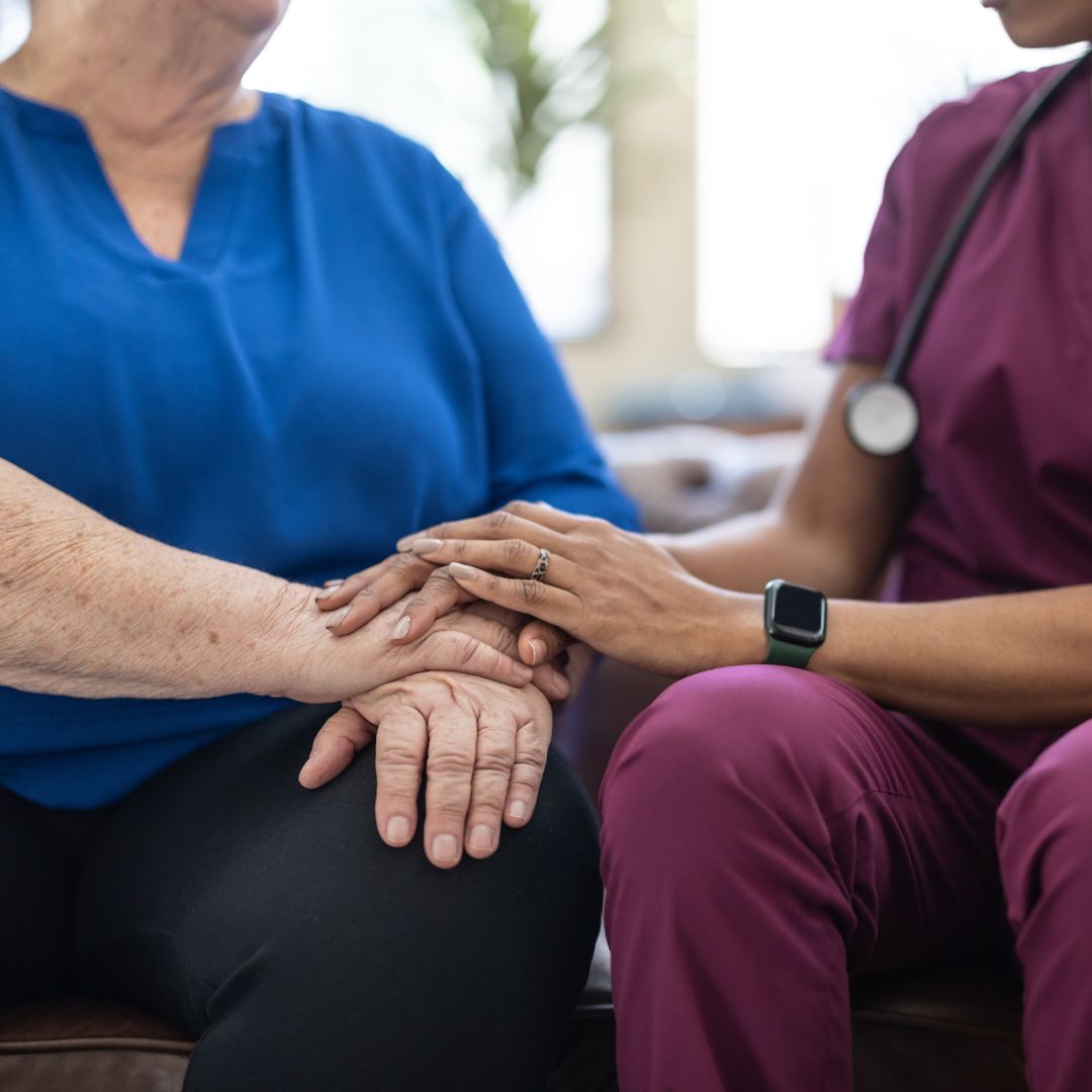 nurse holding patient's hand